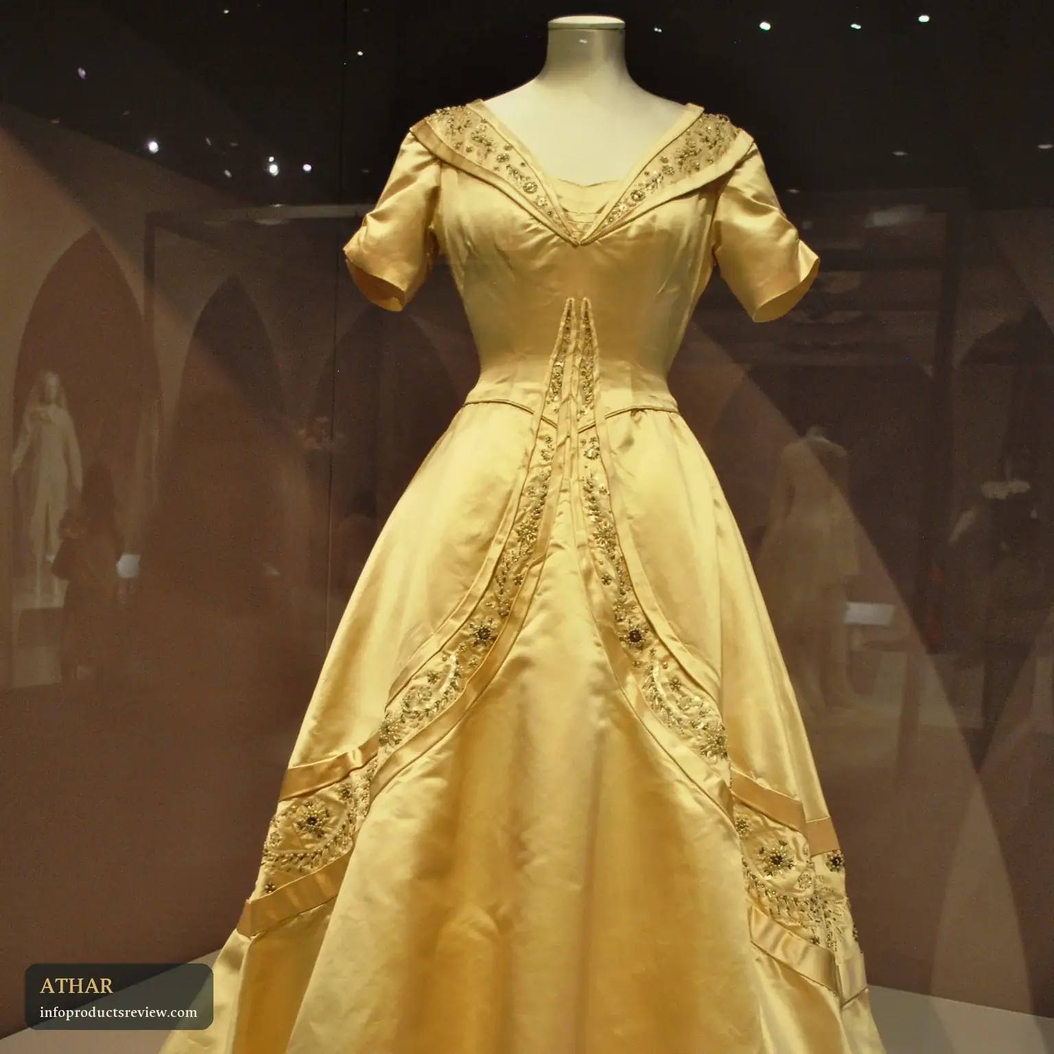 A wedding dress displayed on a mannequin in a museum